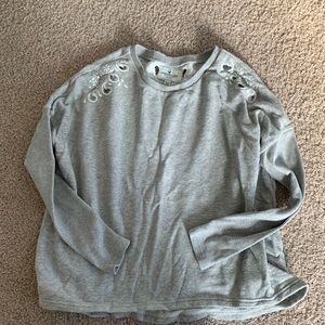 Grey Sweatshirt with cut out detailing.